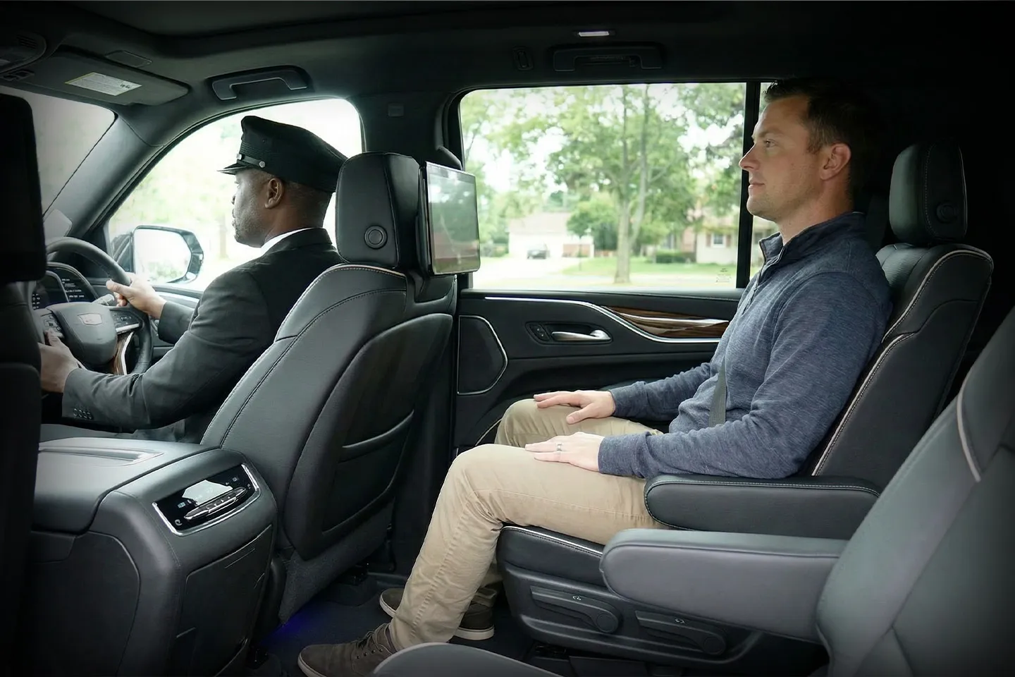 Professional chauffeur assisting passenger in Nassau NY