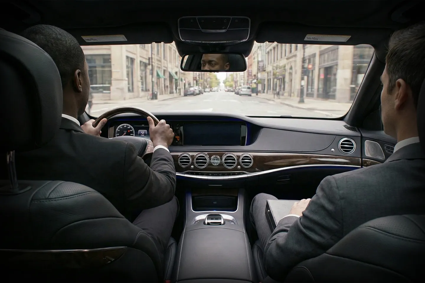 Professional chauffeur assisting passenger in Manhattan NY service