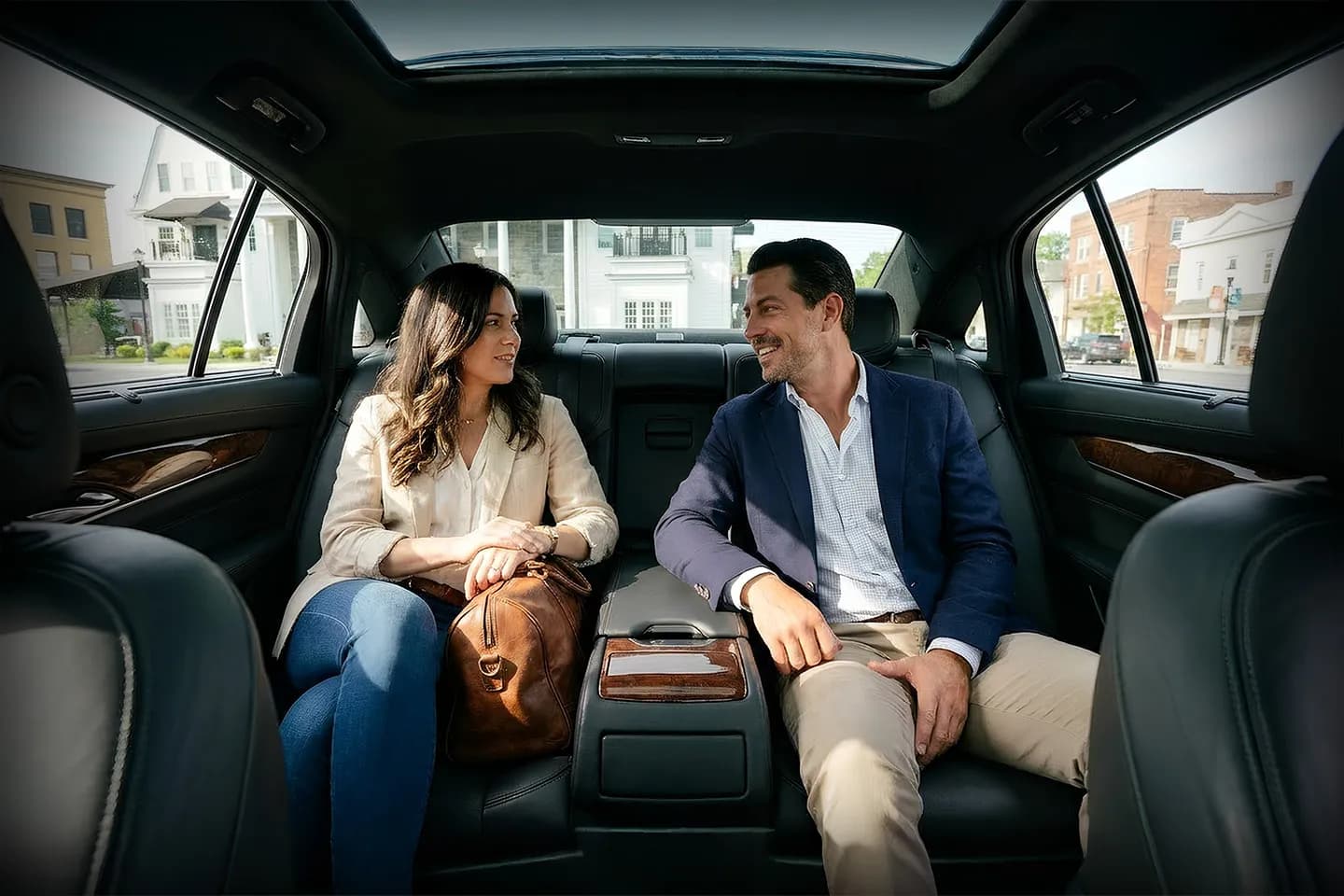 Professional chauffeur opening car door for client in Hamilton NY luxury chauffeur service setting