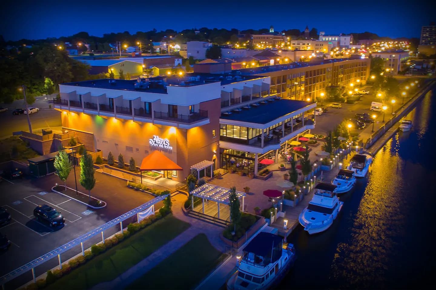 Chauffeur opening door for client using Oswego NY chauffeur service at airport terminal arrival area