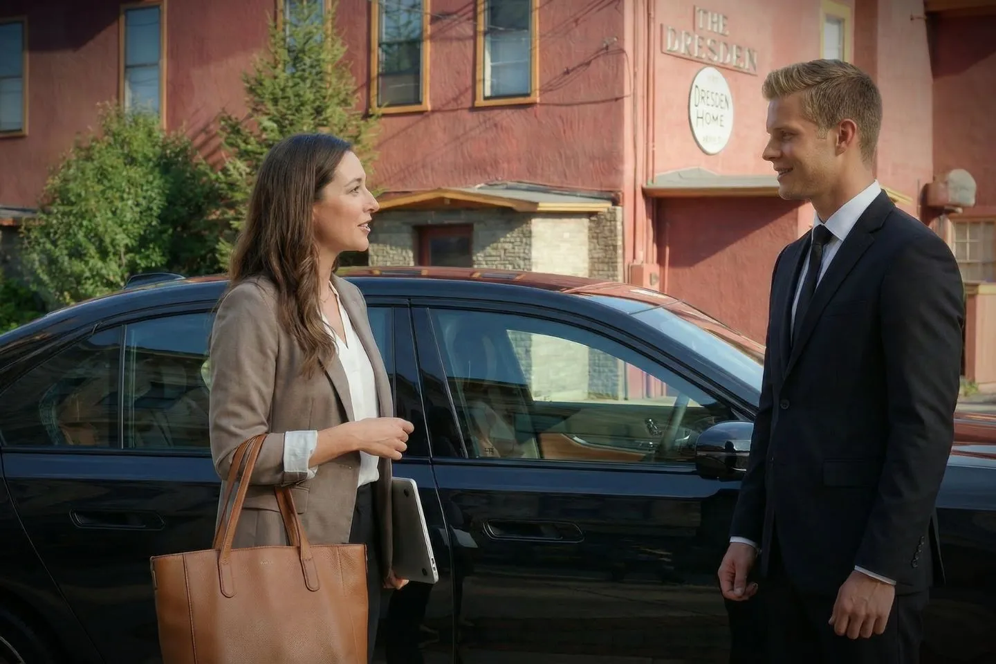 Chauffeur assisting passenger outside event venue in Yates, NY