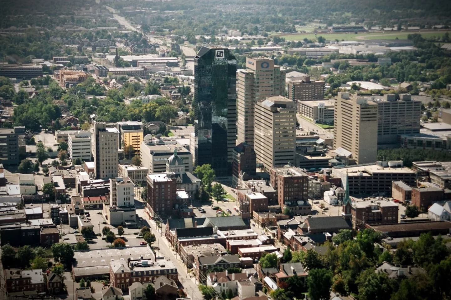 Chauffeur assisting passenger with luggage during Kentucky airport car service transfer