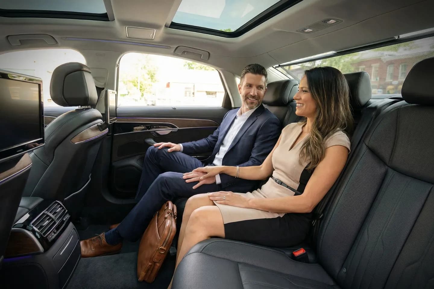 Maine, ME car service chauffeur opening door for executive passenger near business district