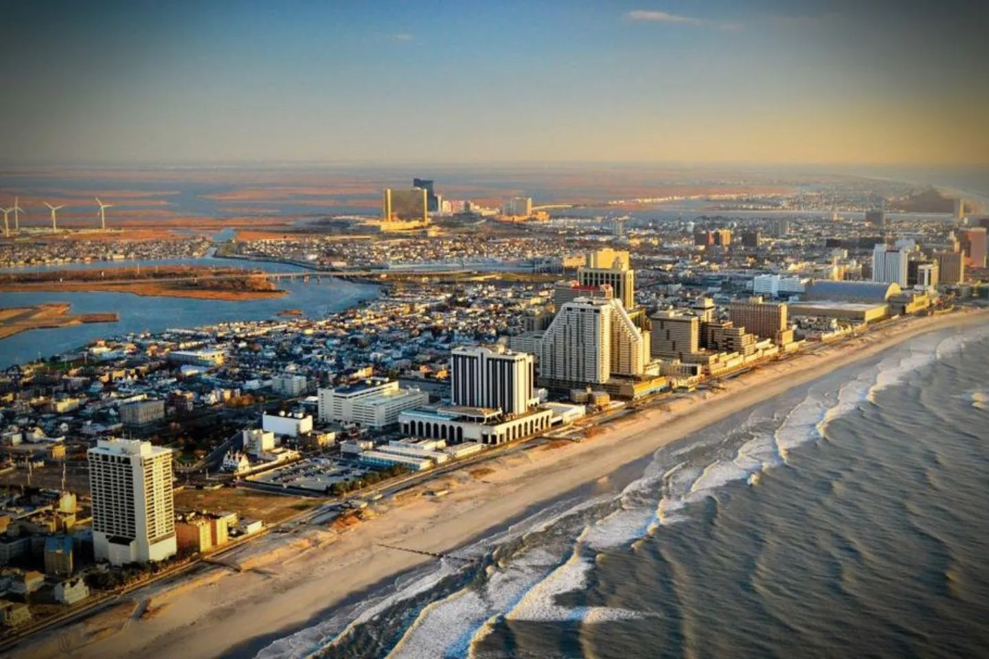 Chauffeur opening door for passenger using Atlantic NJ car service in city setting