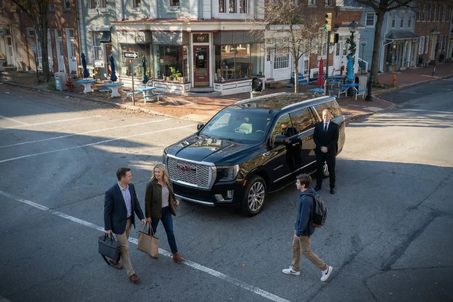 Burlington NJ car service luxury sedan with professional chauffeur assisting passenger curbside