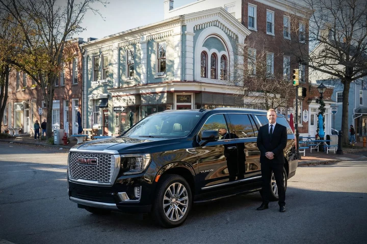 Nighttime pickup by Burlington NJ car service featuring professional driver and luxury SUV