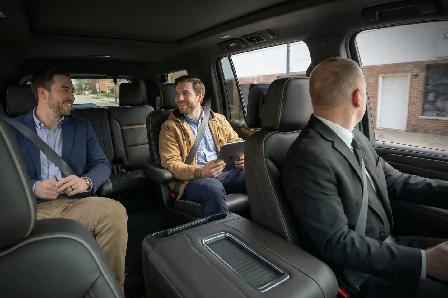 Chauffeur opening SUV door for Somerset NJ Car Service clients at hotel in Somerset