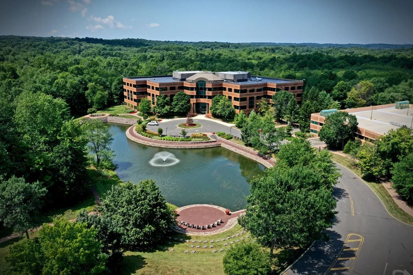 Business traveler entering Warren NJ Car Service vehicle with uniformed chauffeur and polished sedan
