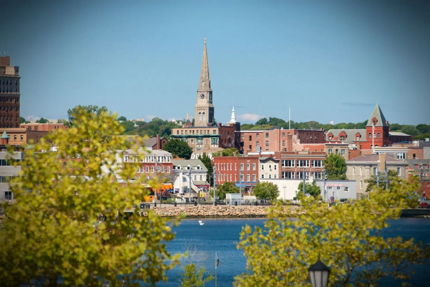 New London CT car service chauffeur assisting passenger with luggage at airport pickup