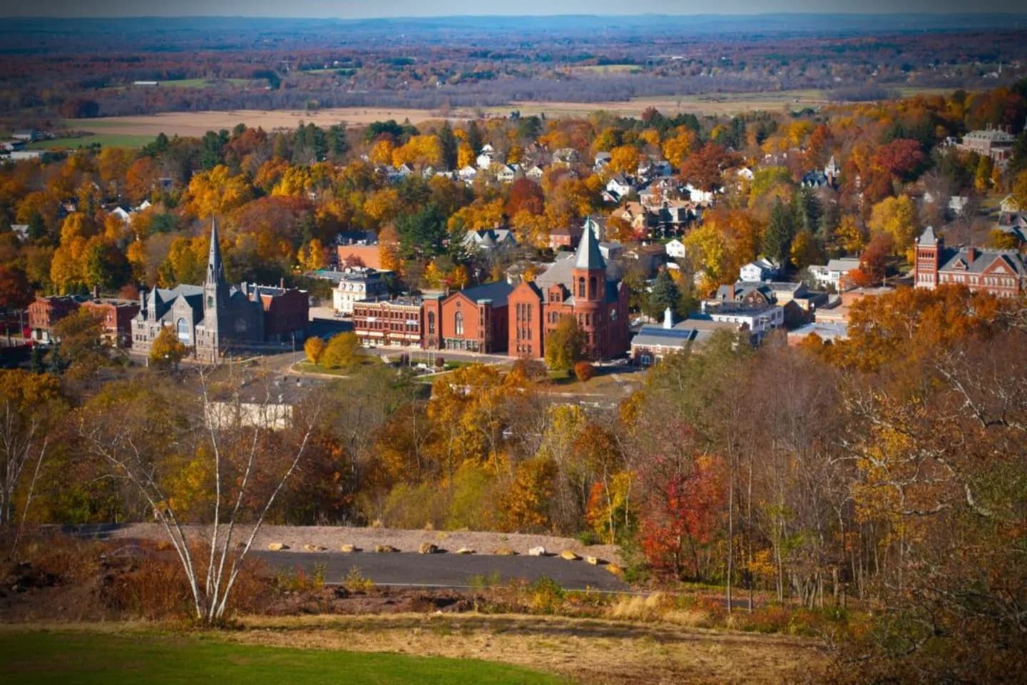 Nighttime airport pickup by Tolland CT car service with chauffeur holding passenger name sign
