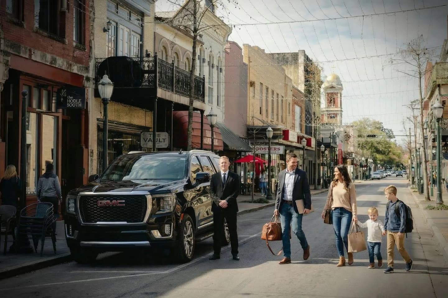 Professional chauffeur opening car door for client using Alabama, AL Chauffeur Service in city setting