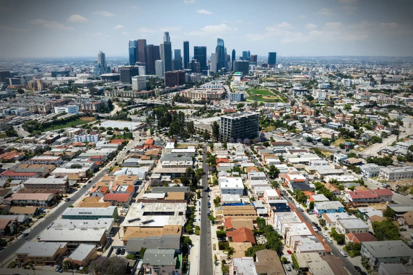 Professional chauffeur driving client through California city streets in premium vehicle service