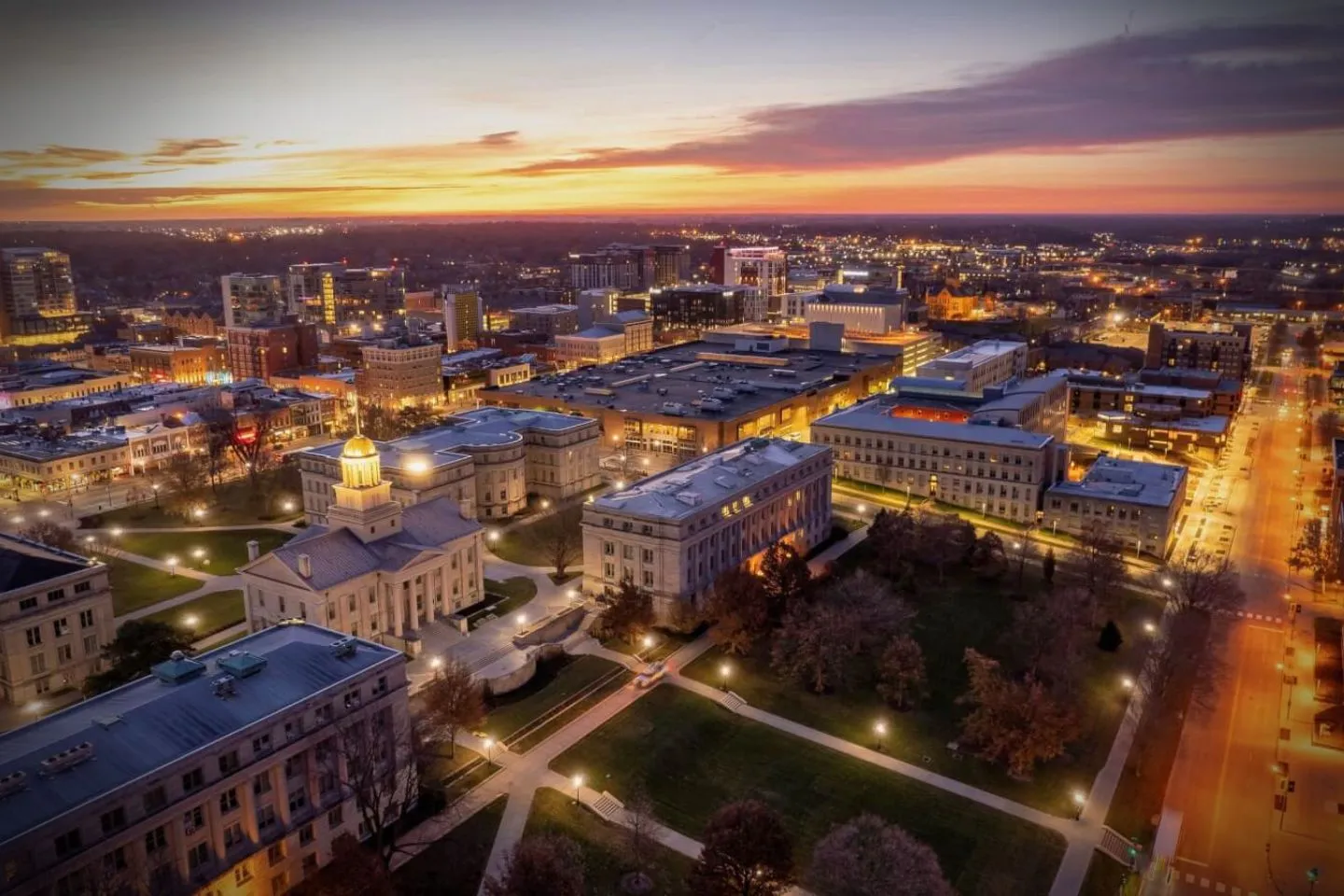 Iowa, IA Chauffeur Service luxury black sedan with professional driver parked at airport terminal