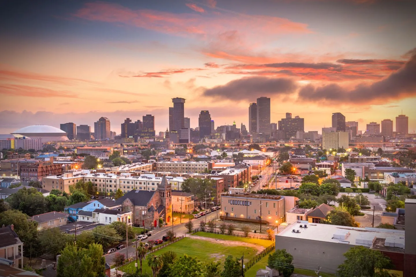 Louisiana, LA Chauffeur Service luxury sedan parked outside upscale hotel with professional driver