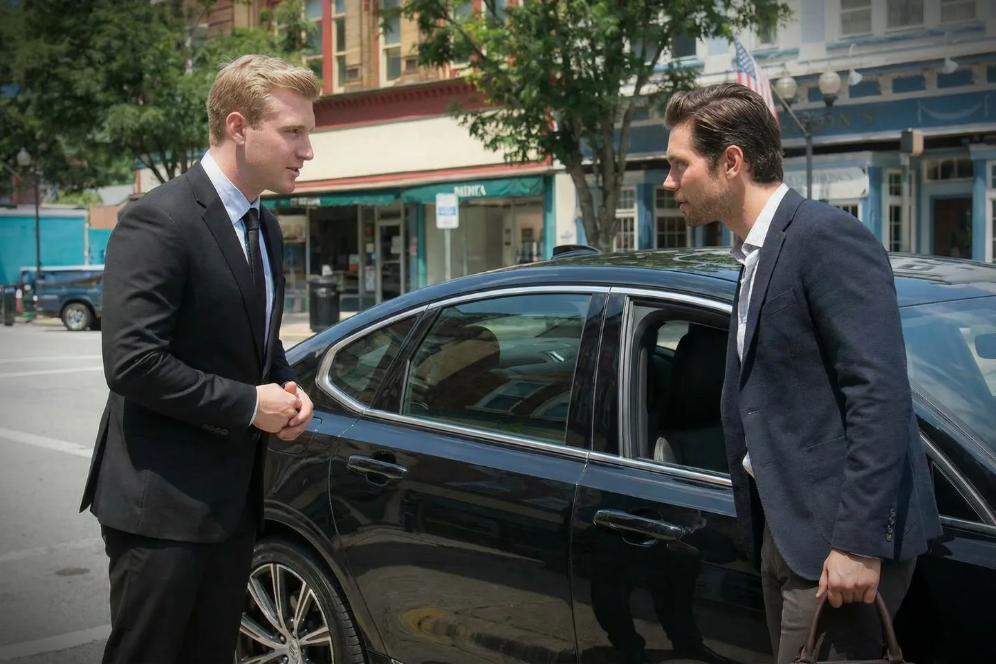 Executive Maryland chauffeur service SUV parked at corporate office building with suited chauffeur
