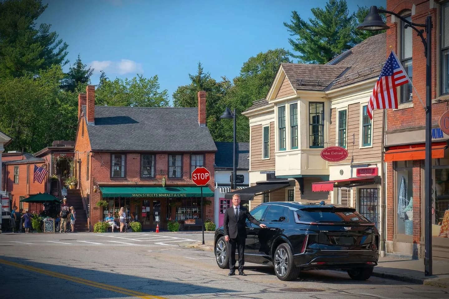 Massachusetts, MA Chauffeur Service luxury sedan parked in downtown Boston with professional driver standing beside vehicle