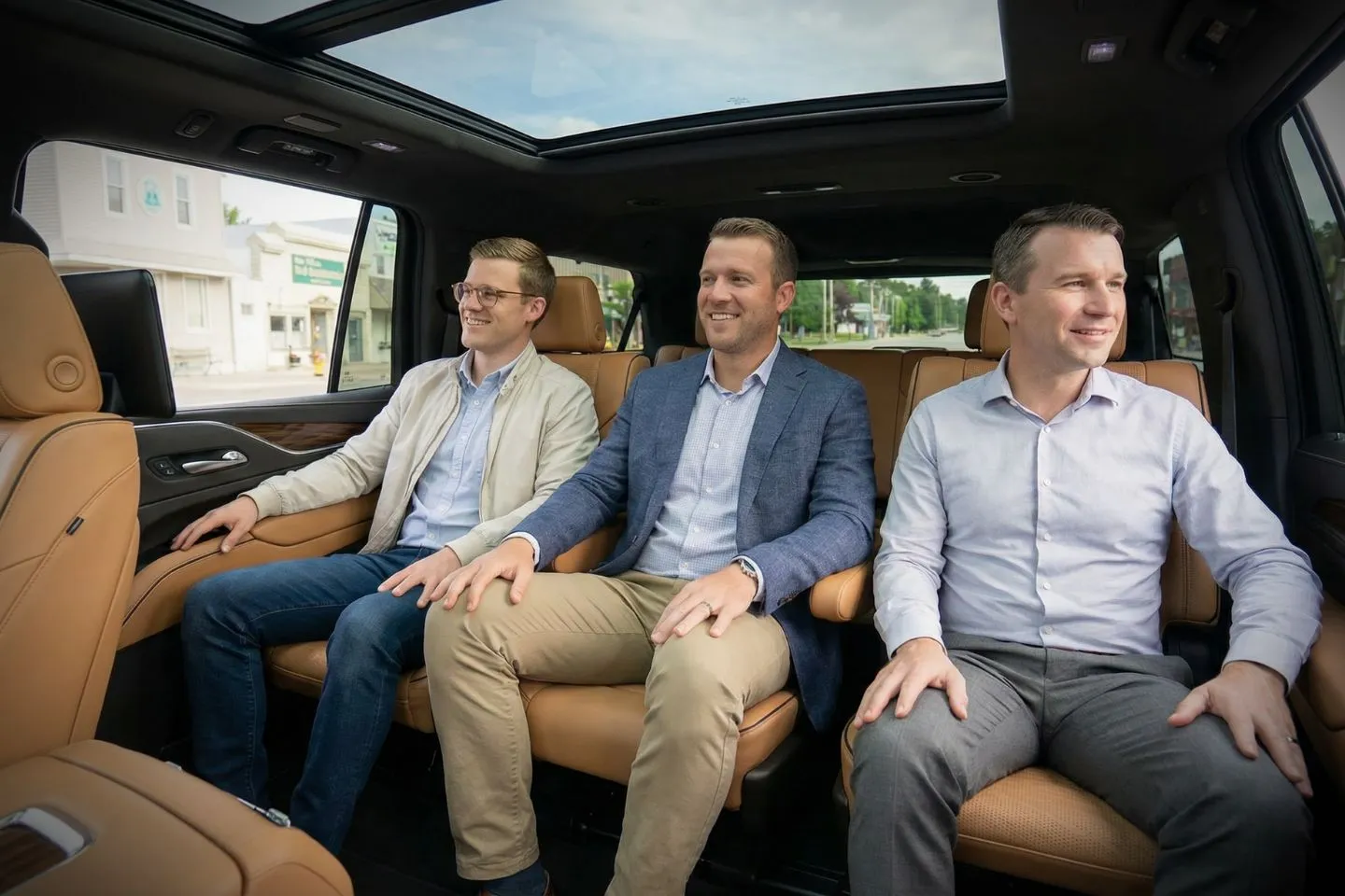 Professional chauffeur opening car door for client using Michigan, MI Chauffeur Service in city setting