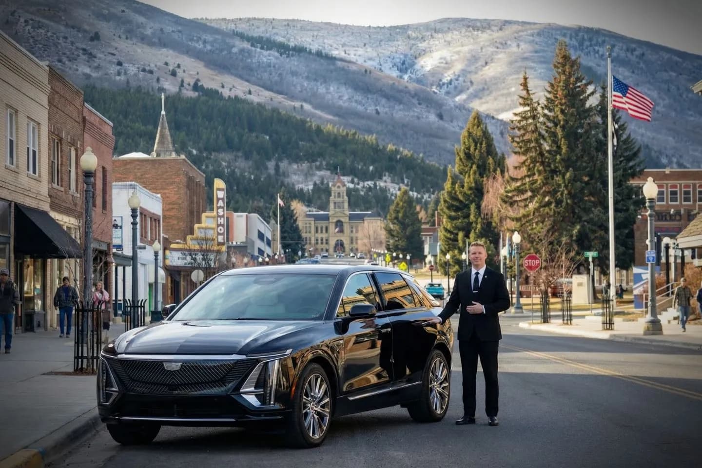 Luxury sedan with Missouri, MO Chauffeur Service parked outside upscale hotel with professional driver ready