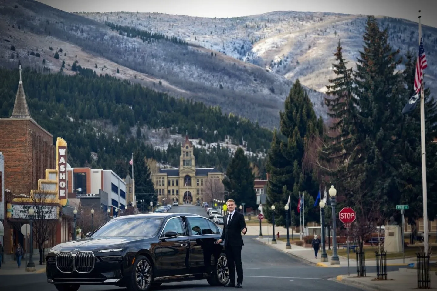Chauffeur driving luxury vehicle through Montana landscape for premium service clients