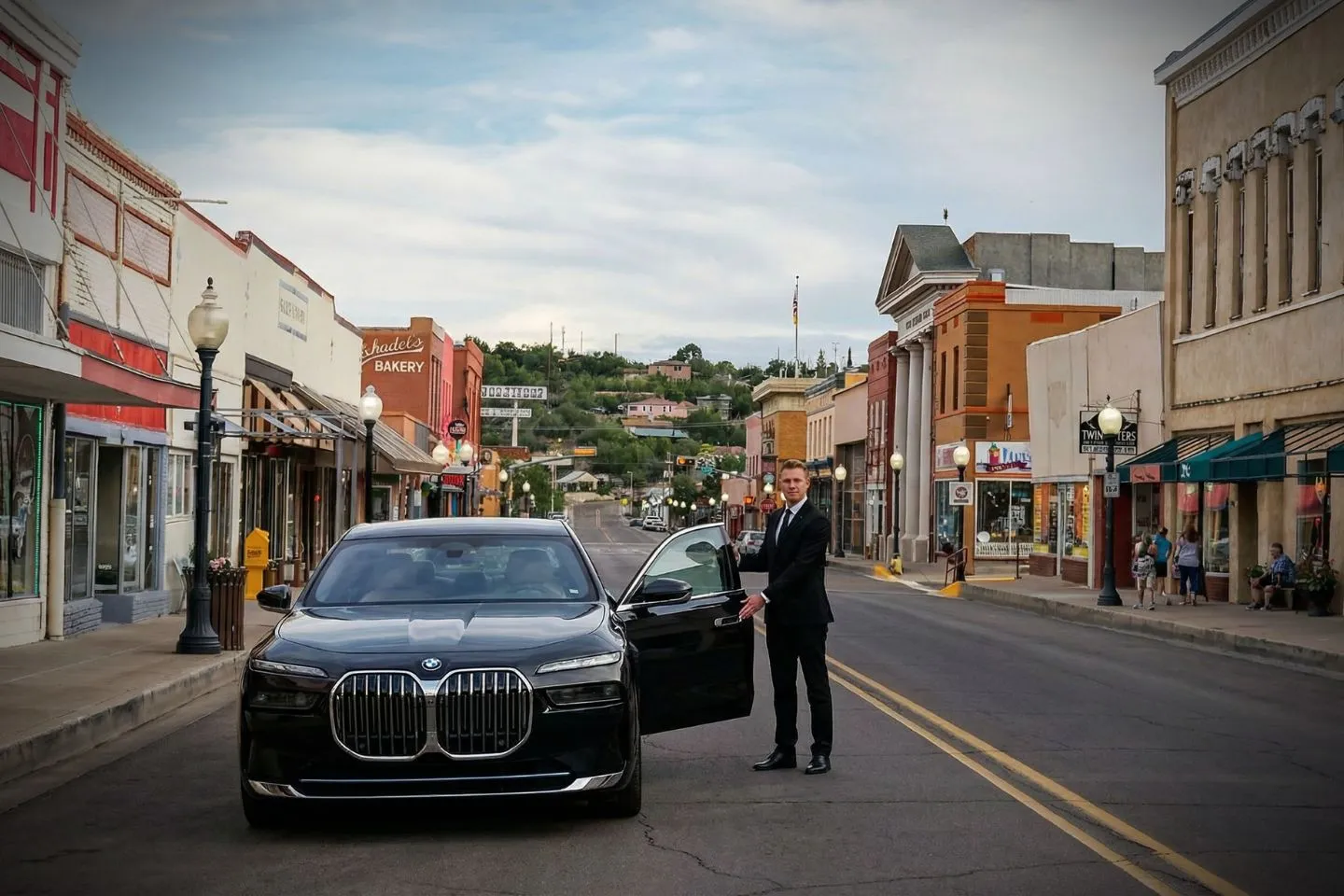 Luxury sedan with chauffeur providing New Mexico, NM Chauffeur Service outside airport terminal