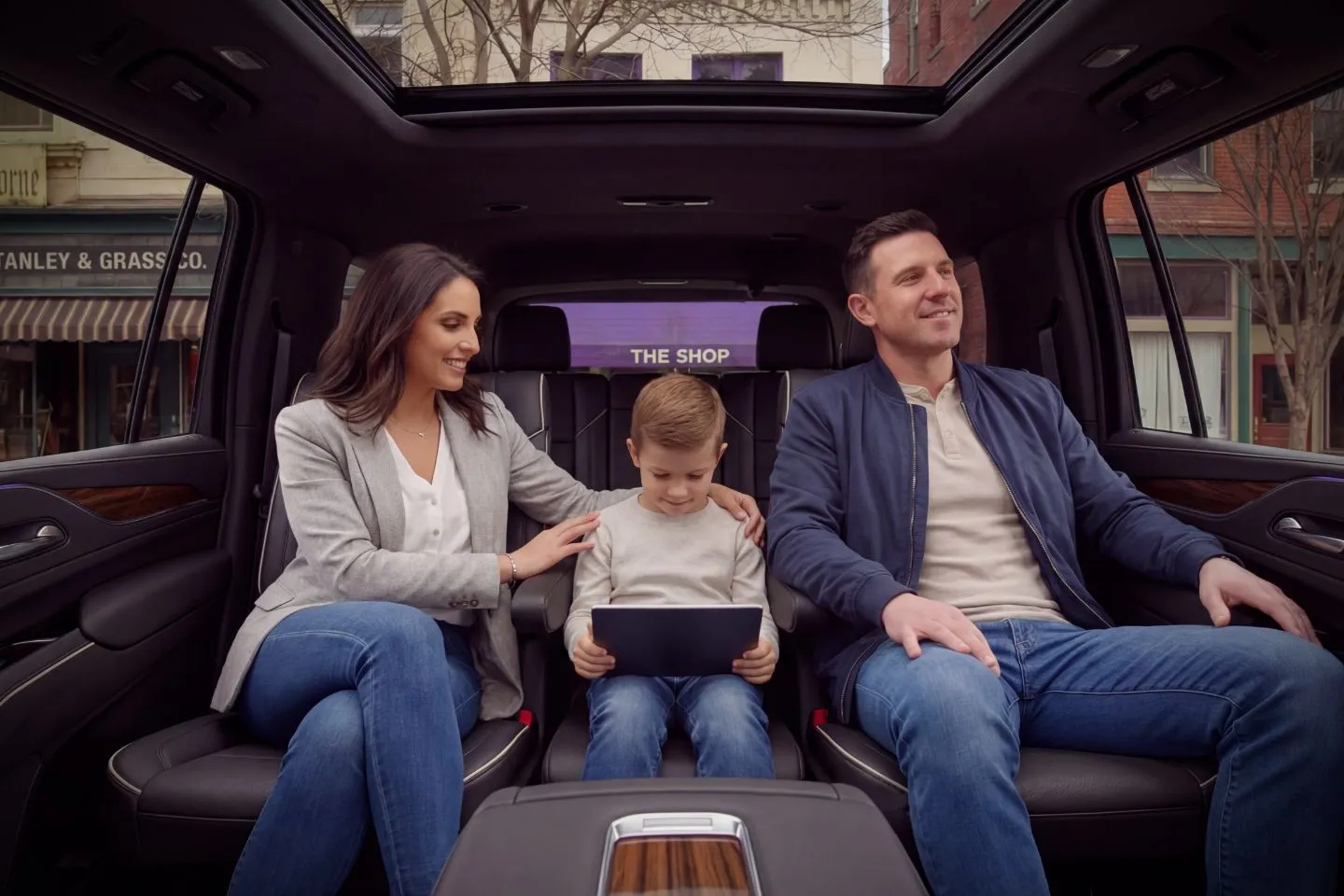 Pennsylvania, PA Chauffeur Service chauffeur opening door of luxury SUV for business traveler in evening city lights