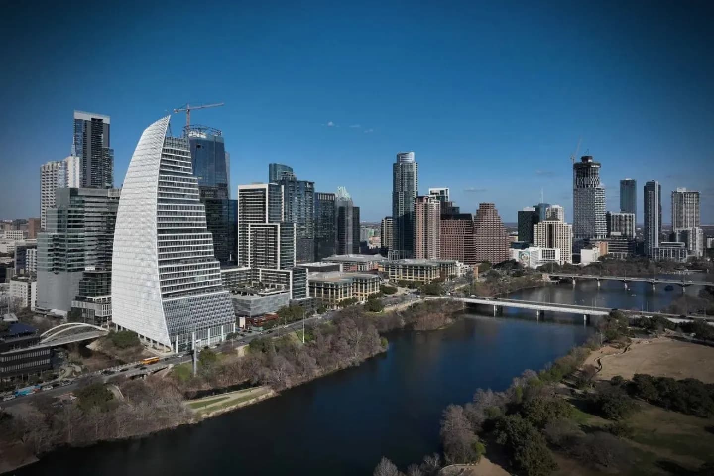 Luxury sedan with professional driver offering Texas, TX Chauffeur Service in downtown business district