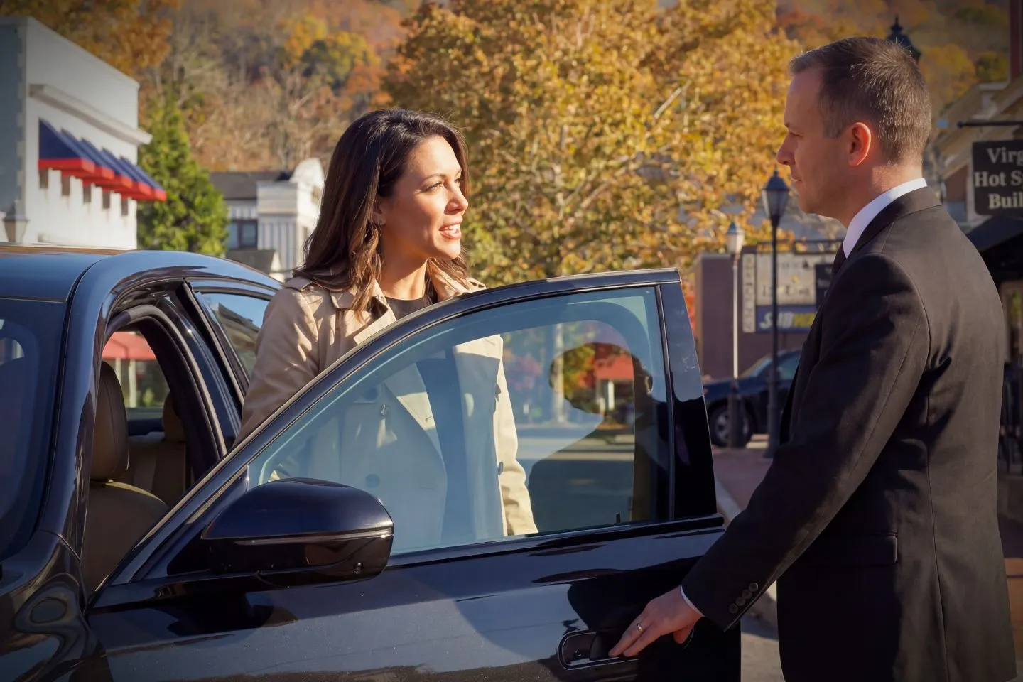 Executive using Virginia chauffeur service stepping into premium SUV at airport terminal