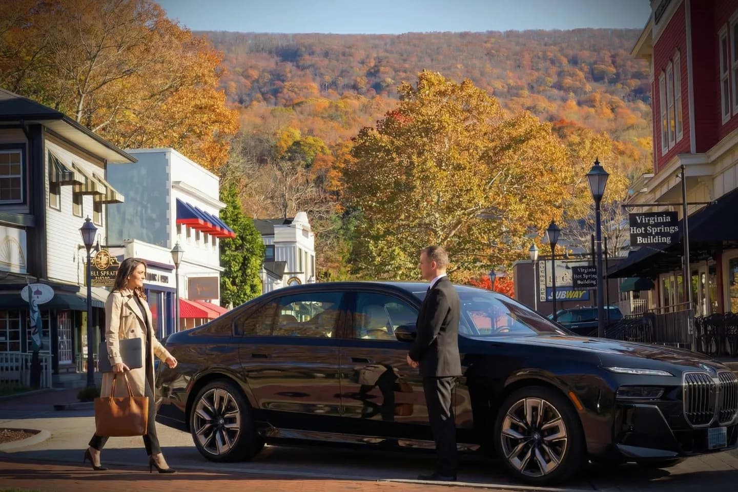 Virginia, VA Chauffeur Service luxury black sedan parked outside upscale hotel with professional driver