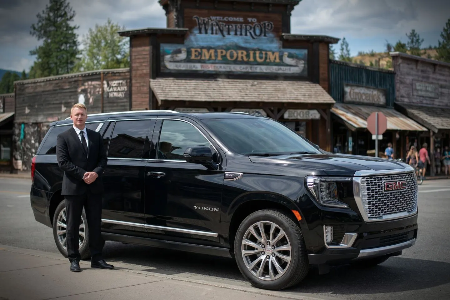 Luxury sedan from Washington, WA Chauffeur Service parked outside downtown business district with professional chauffeur