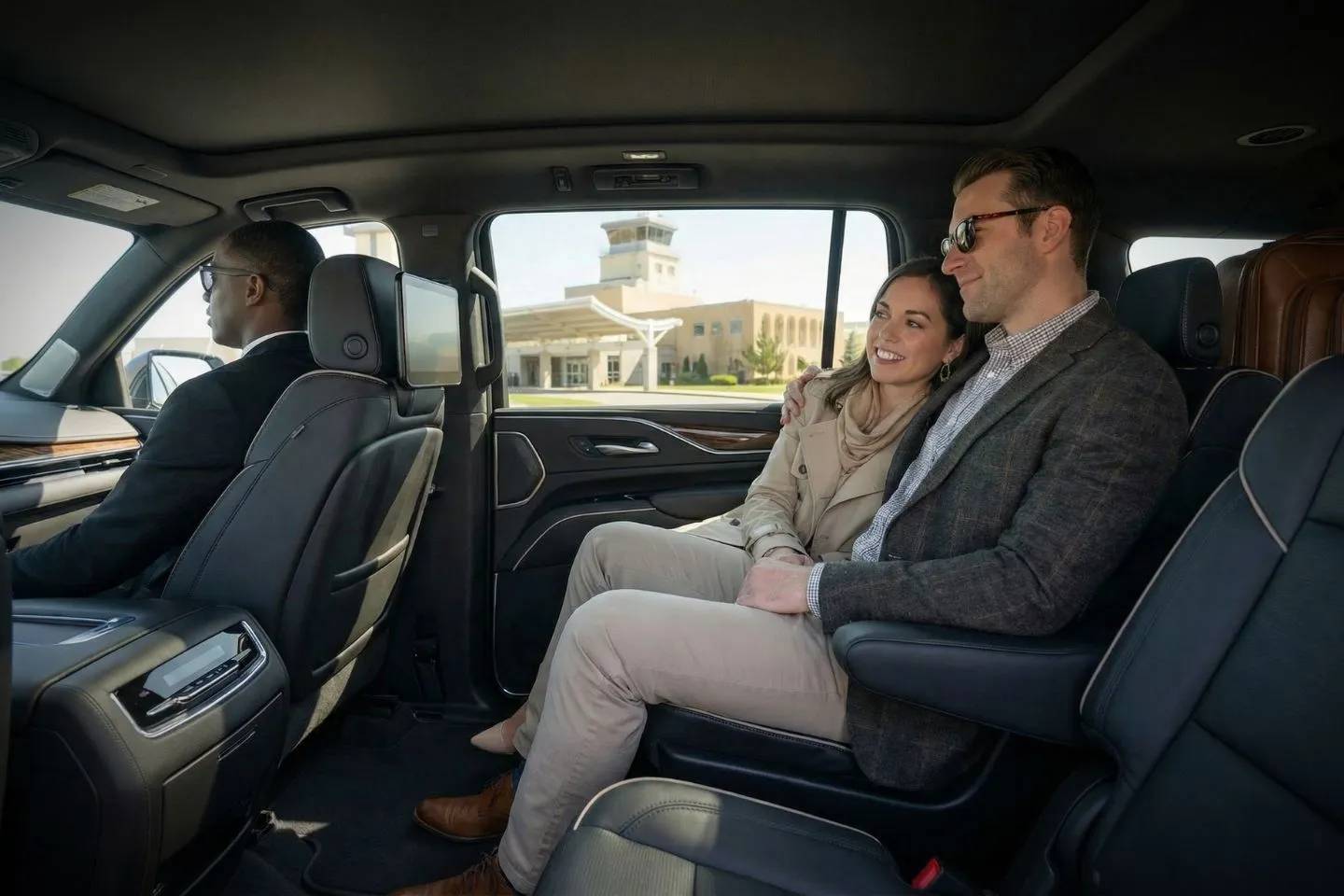 Chauffeur opening door of executive SUV from Idaho car service in downtown Boise business district