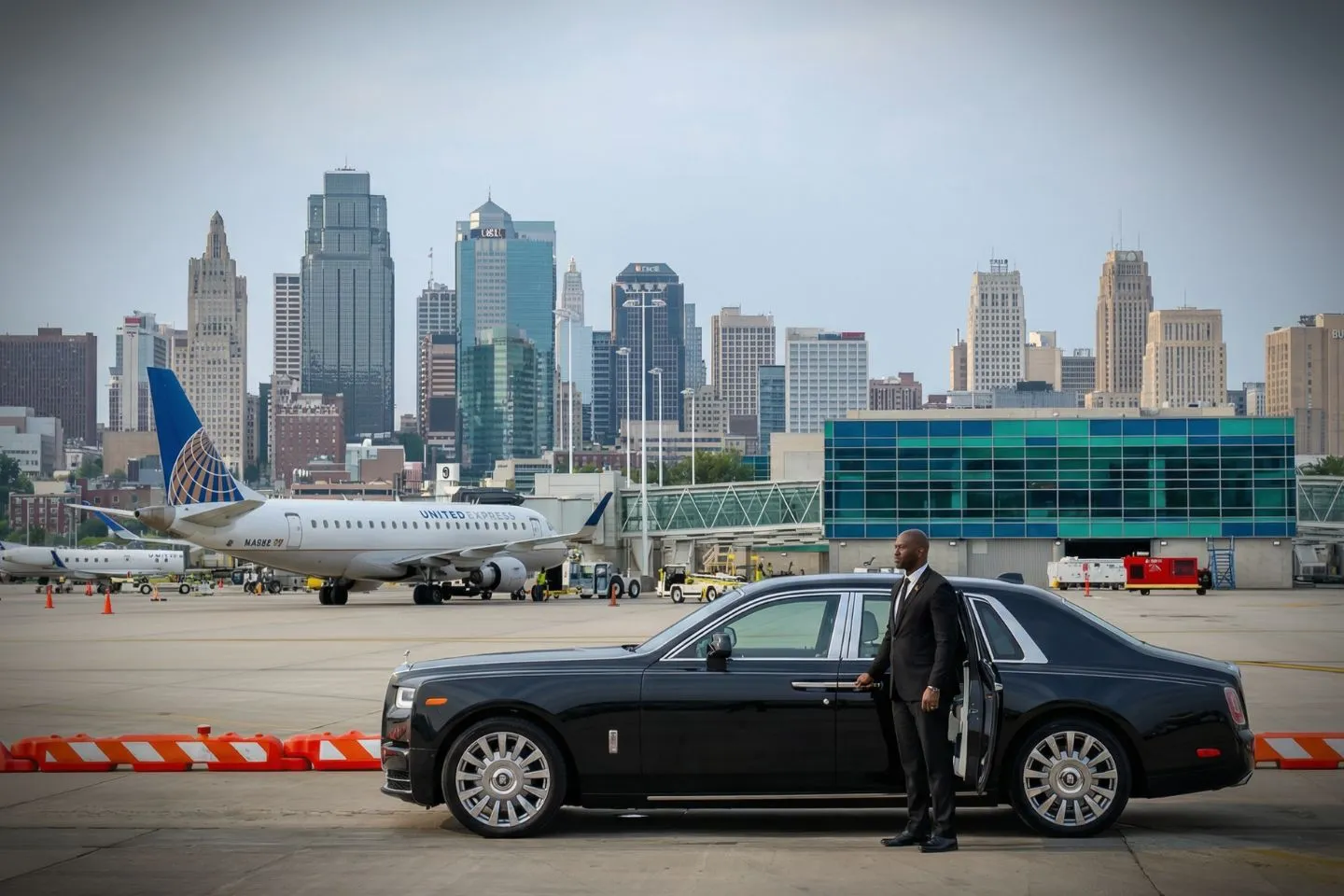 Professional driver offering Missouri MO Car Service ride with premium black car on city street