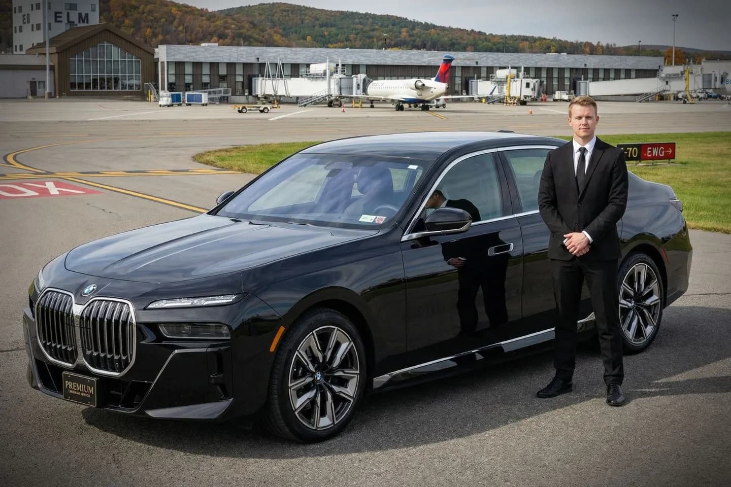 Chauffeur assisting passenger with luggage Elmira Corning Regional (ELM) Car Service New York NY