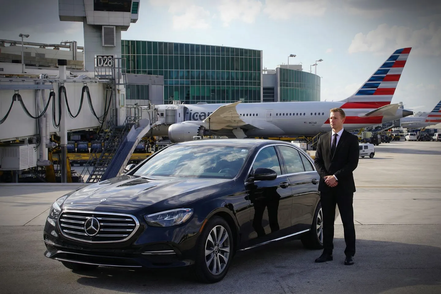 LBE Car Service chauffeur assisting passenger at Miami airport terminal