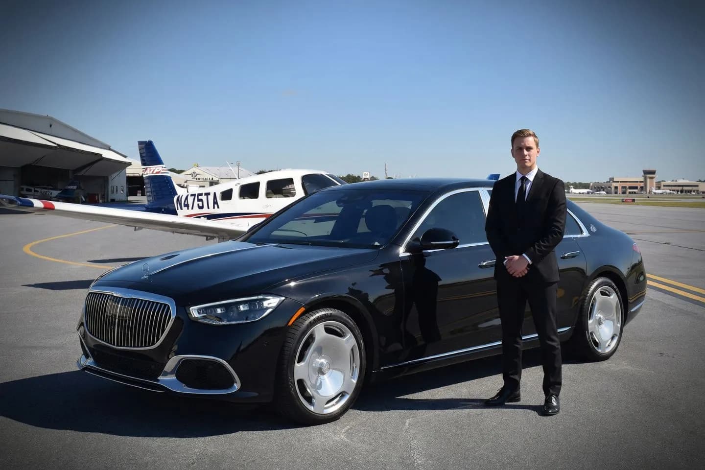 LBE Car Service chauffeur assisting passenger at Jacksonville airport terminal