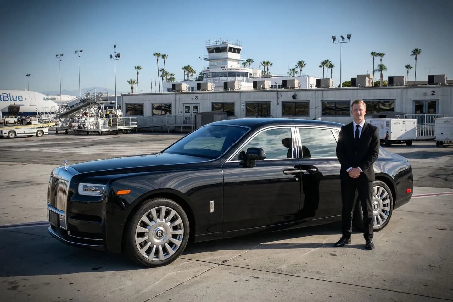 Union Limousine chauffeur loading luggage at LGB Long Beach airport curbside