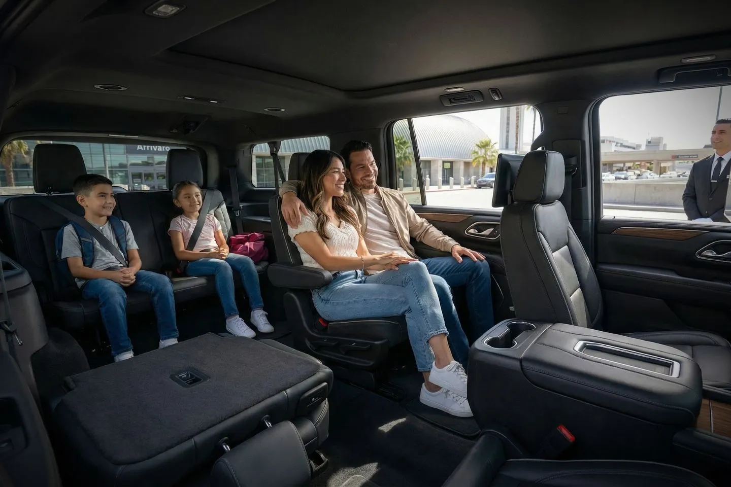 Luxury black sedan at John Wayne Airport SNA Orange County terminal curbside