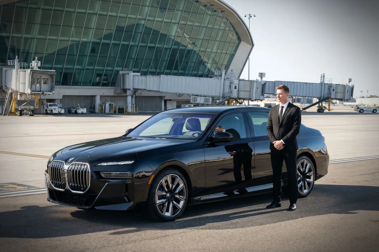 Luxury black sedan at Fresno Yosemite International Airport FAT terminal curbside