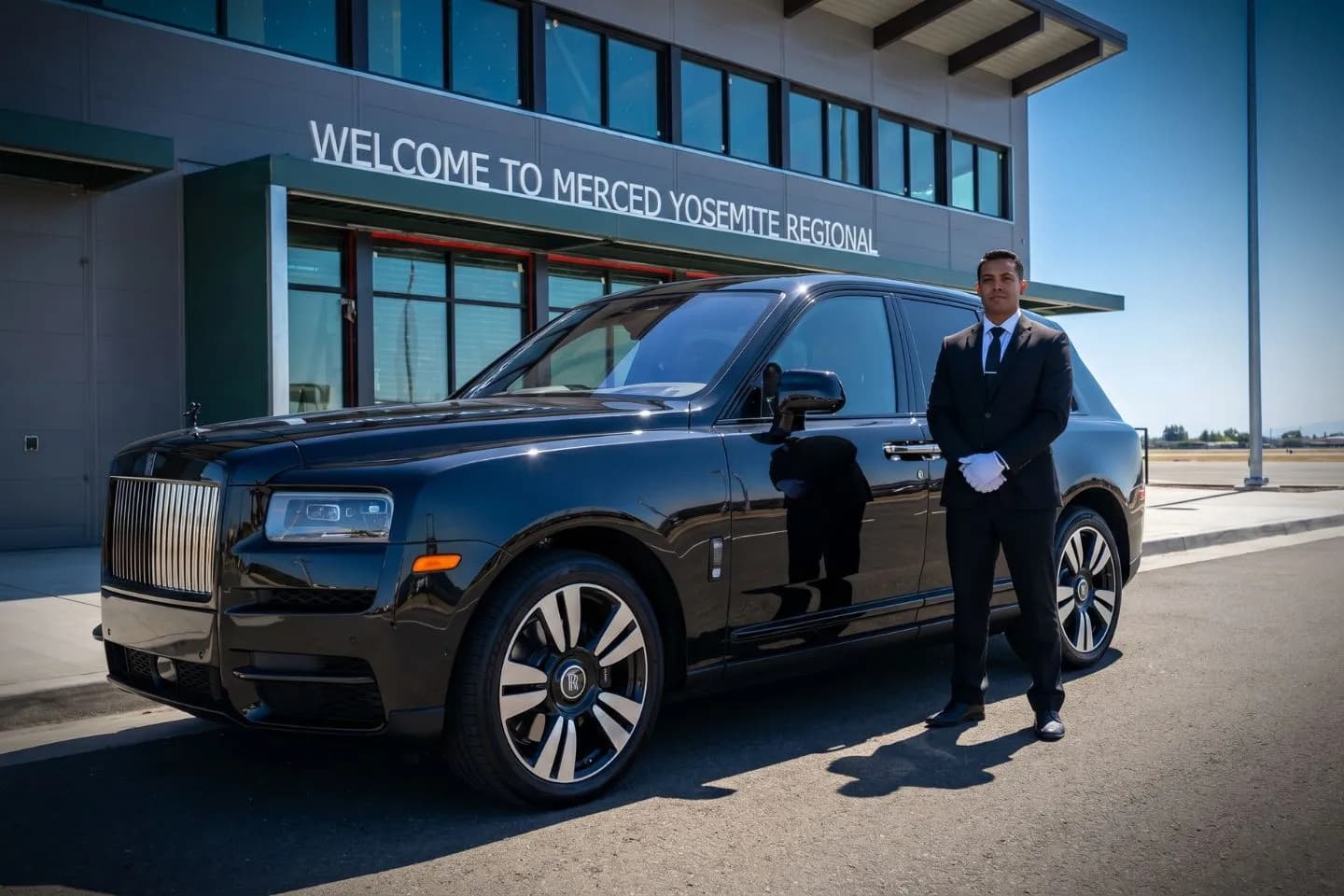 Black BMW 7 Series chauffeured car at Merced Regional airport for Central Valley business travel
