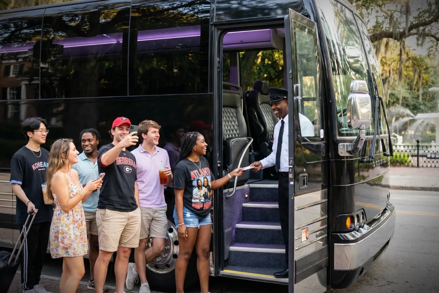 Motorcoach traveling along an interstate near the Atlanta skyline on a Georgia charter route