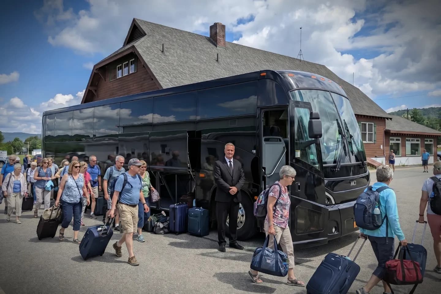 Charter bus waiting outside Adirondack Regional Airport for a mountain tour group