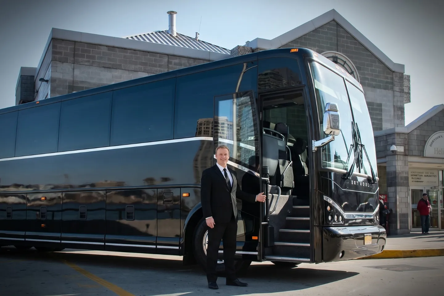 Business group boarding a charter bus rental at Downtown Manhattan Heliport