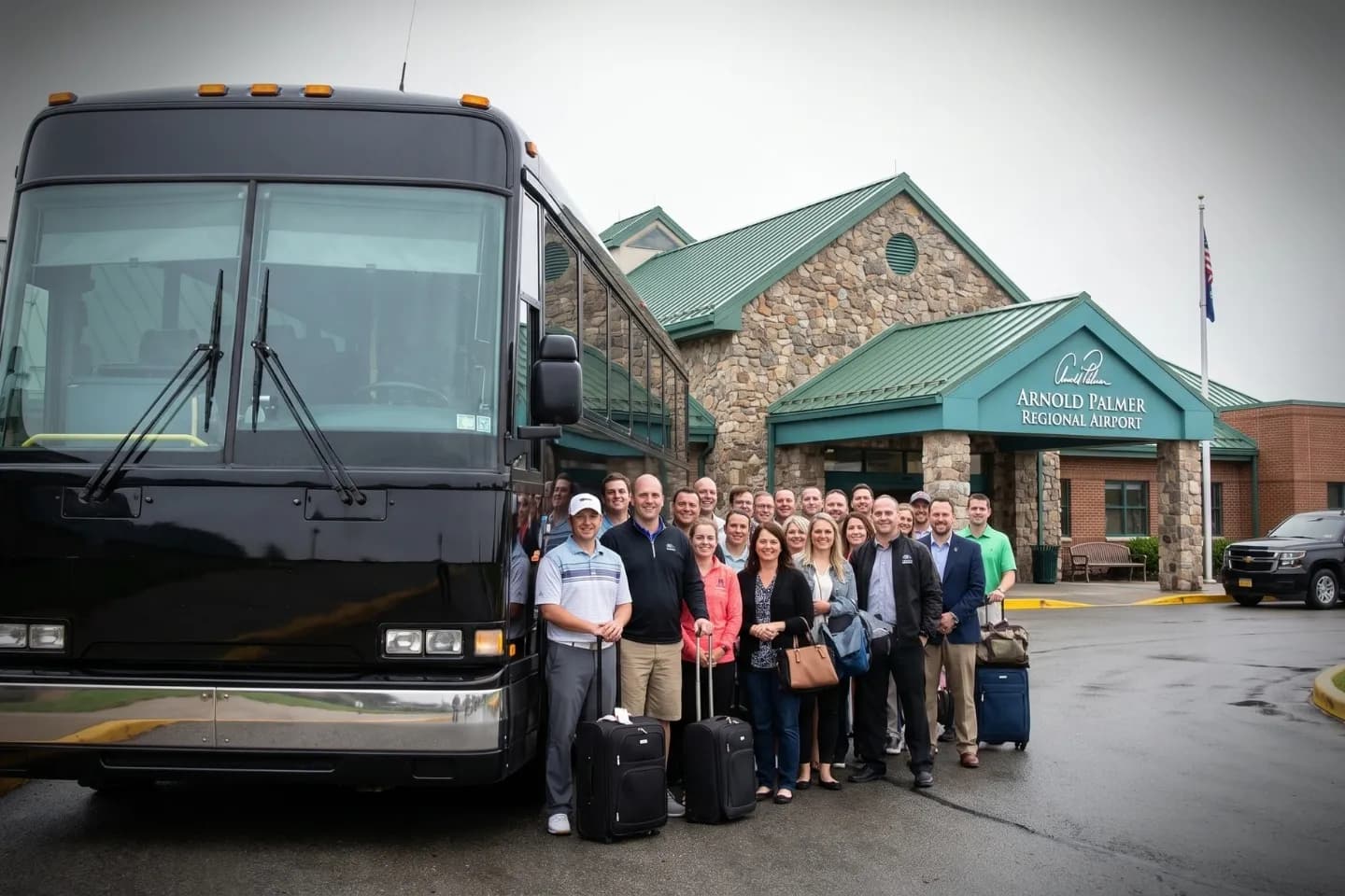 Chauffeur loading bags into an LBE Airport charter bus