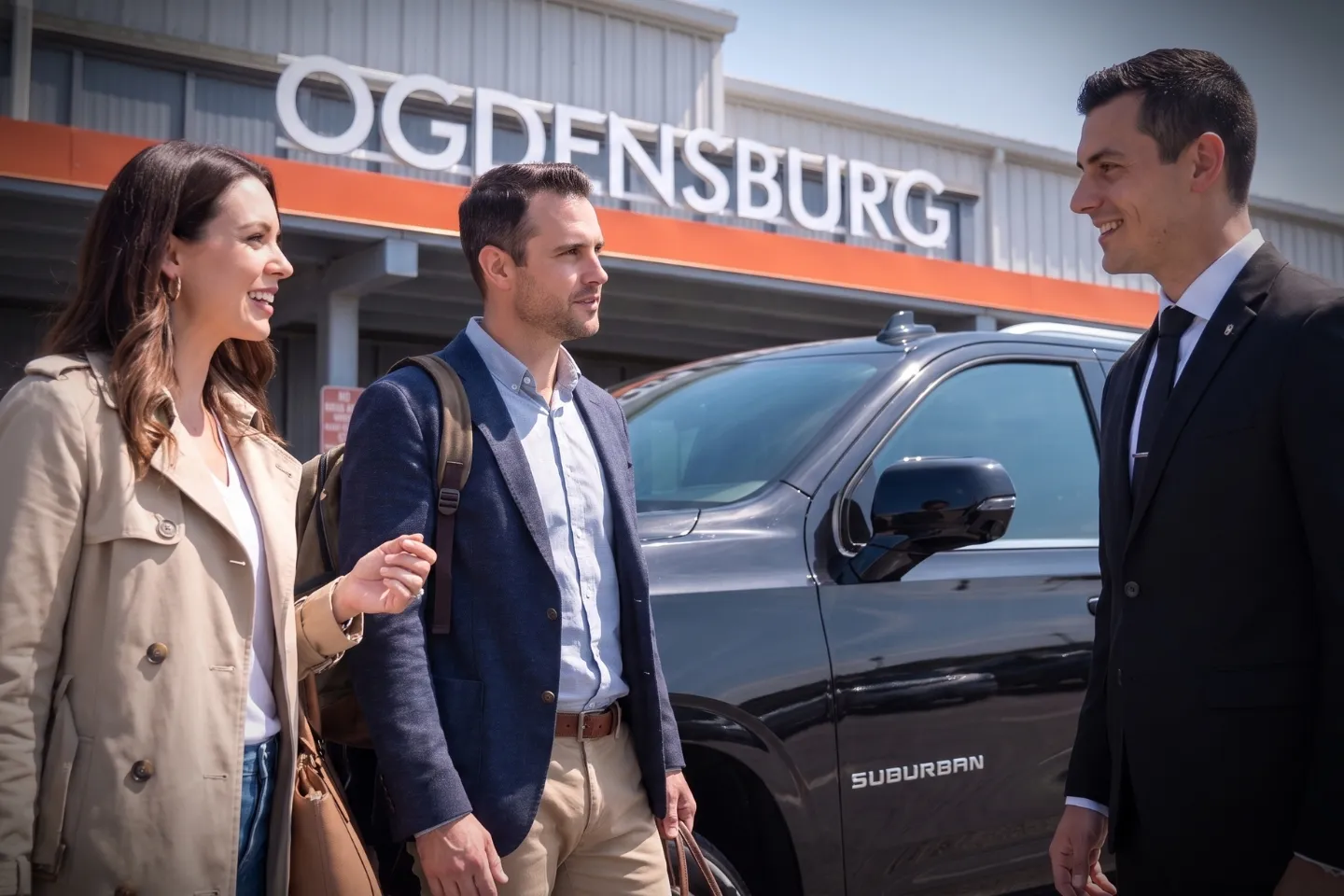 Luxury SUV waiting curbside at Ogdensburg Airport for a private chauffeur transfer