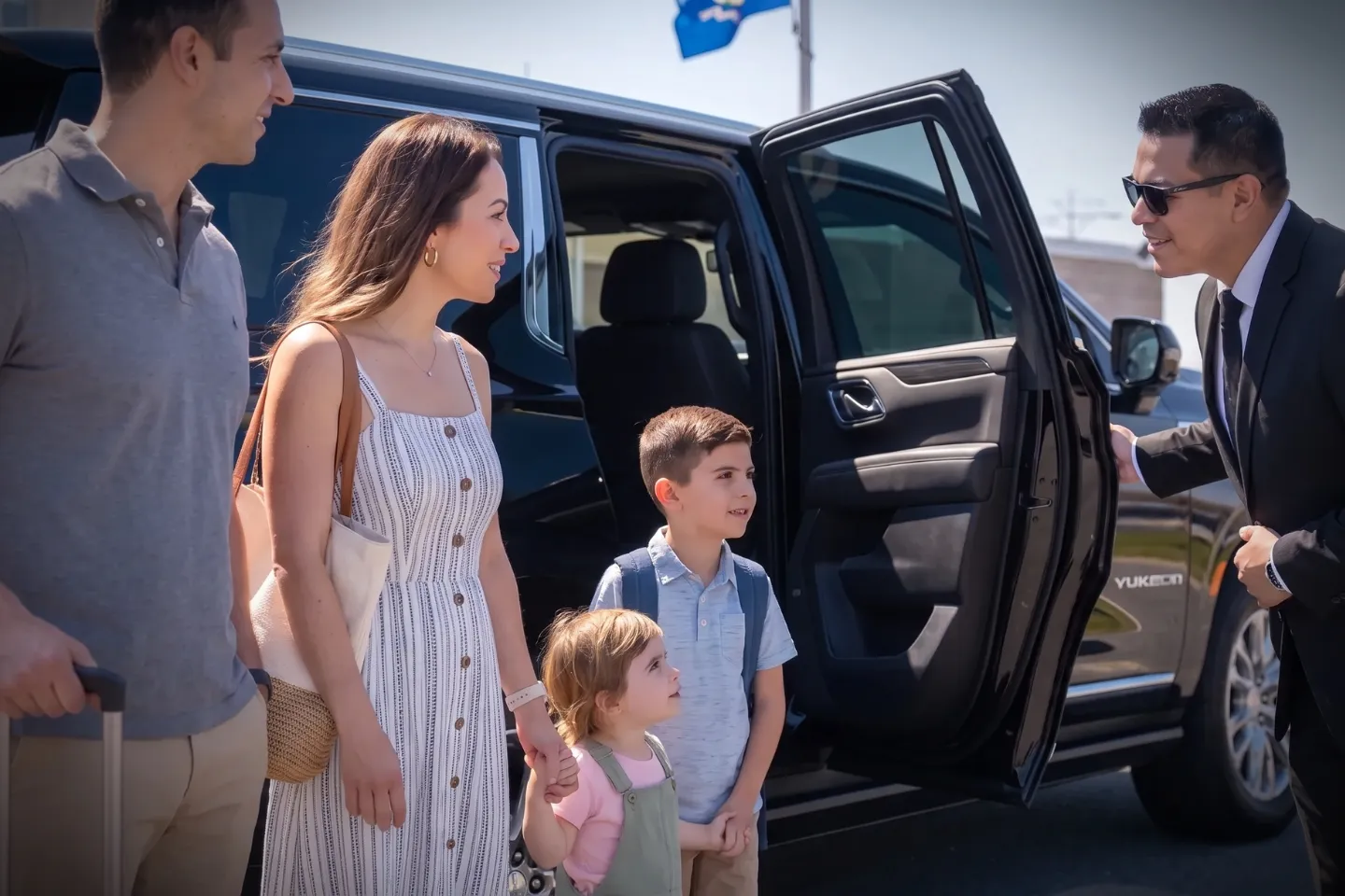 Professional driver opening rear door at Groton New London (GON) Airport