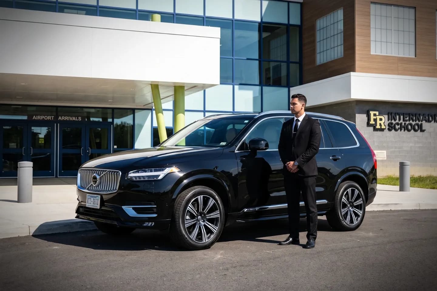 Professional chauffeur opening the rear door at Franklin Regional Airport (FKL)