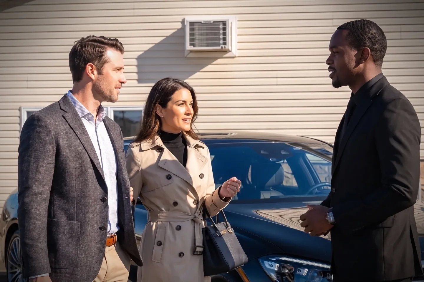 Professional chauffeur opening the car door for a passenger at LLY private aviation area