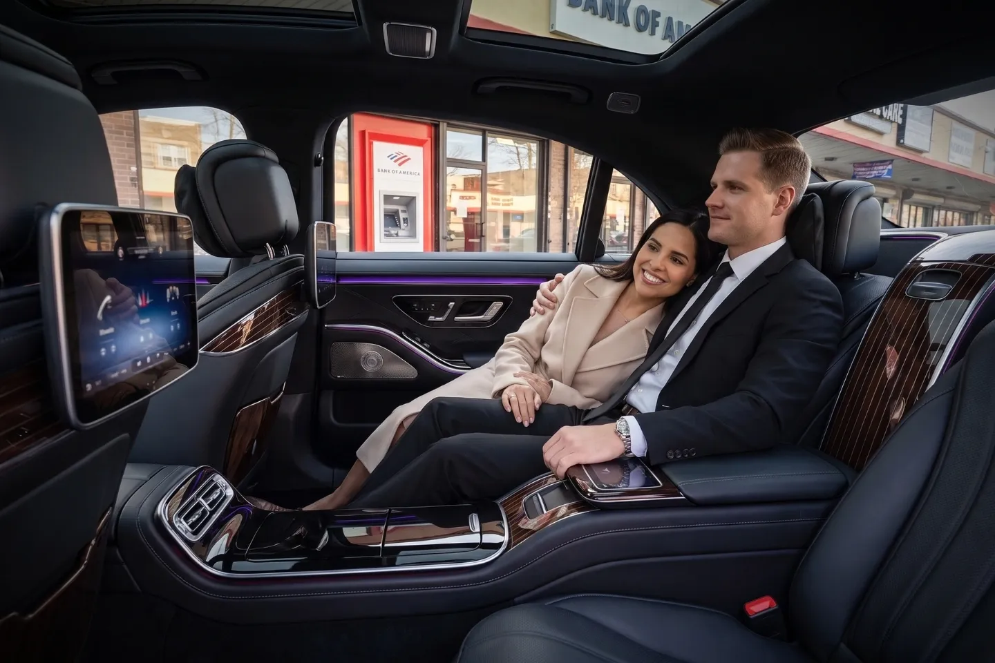 Chauffeured sedan traveling along a tree-lined street in Edenwald, Bronx