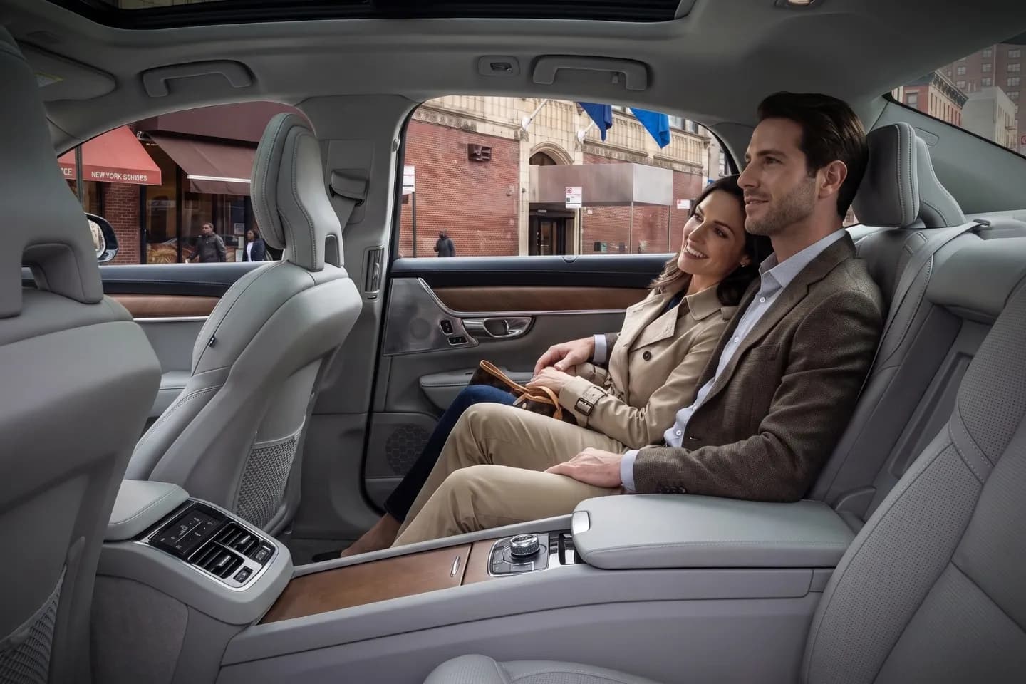 Professional chauffeur opening a rear door for a passenger in Fordham Heights, Bronx