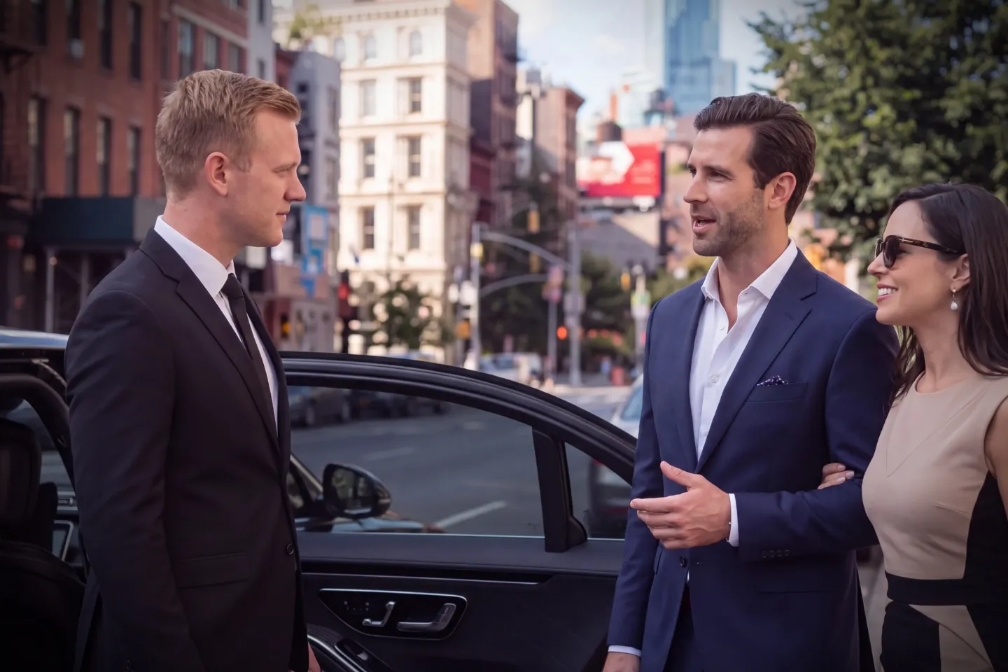 Premium black car driving past historic buildings in Bowery, Manhattan
