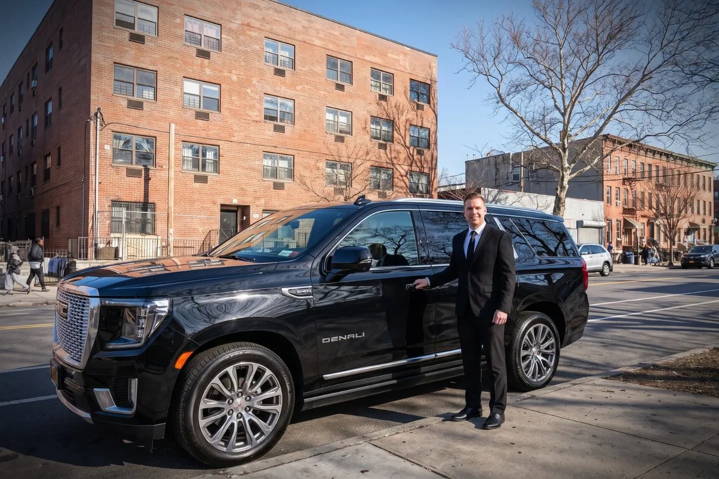 Sleek executive SUV waiting outside a residence in Laconia, Bronx NY